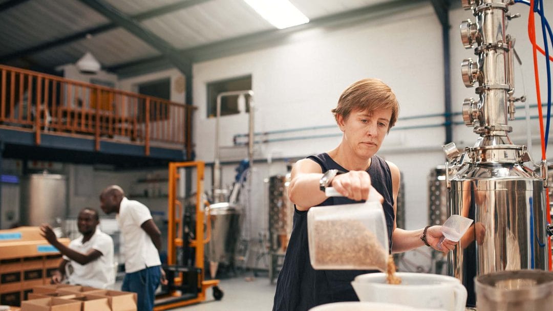 A woman measuring out barley for processing